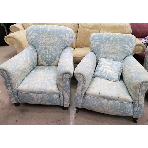580 - A pair of Edwardian arm chairs upholstered in traditional blue fabric