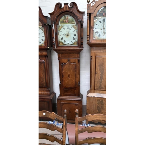 575 - An early 19th century longcase clock in inlaid crossbanded oak, the hood with swan neck pediment and... 