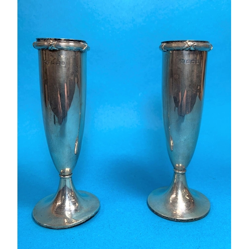 333 - A silver pair of posy vases of tapering form with reeded rims, on weighted bases, Birmingham 1906