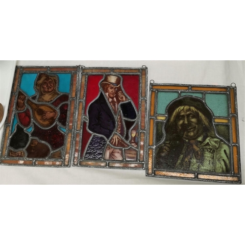 223 - Three leaded and coloured glass panels depicting a Jester, a drunk and a man in top hat; a 1930's sp... 