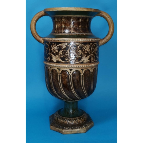 241 - A Martin Bros stoneware gothic 2 handled urn in the form of a font with stepped octagonal base, sgra... 
