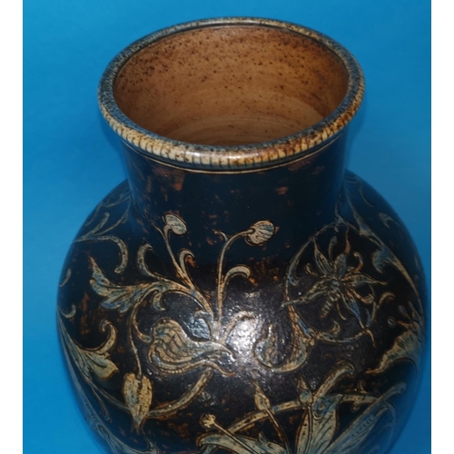 242 - A stoneware bulbous vase by Martin Brothers, with incised decoration of scrolling orchids, blue on b... 