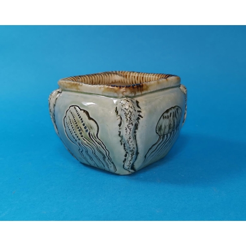 243 - A Martin Bros stoneware open cache pot of square cushion form, decorated in sgraffito with jellyfish... 
