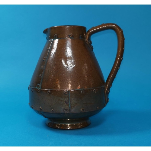 257 - A Doulton Lambeth silconware stoneware jug in the shape of a Victorian copper ale jug, probably exhi... 