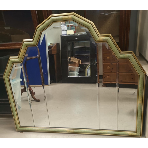 517 - A modern bevelled glass wall mirror in cushion frame
