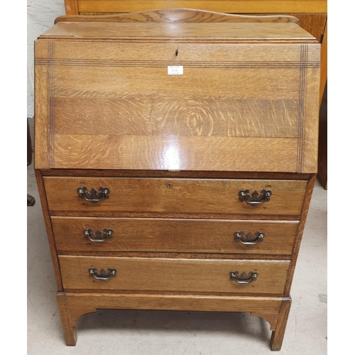 534 - An early 20th century oak fall front bureau with 3 drawers below