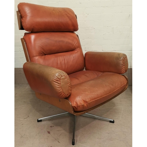 537 - After Herman Miller Eames, a mid 20th century swivel arm chair, with teak venered support on chrome ... 