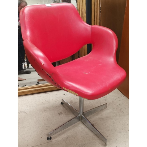 605 - A mid 20th century design swivel chair in chrome and red leather effect