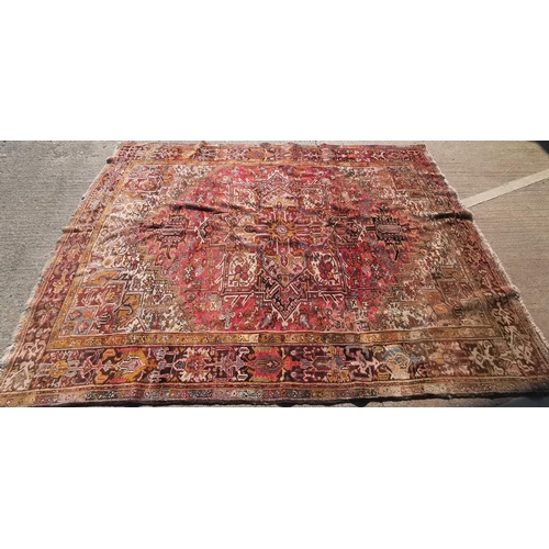 628 - A large hand knotted rust ground carpet with geometric pattern, 137