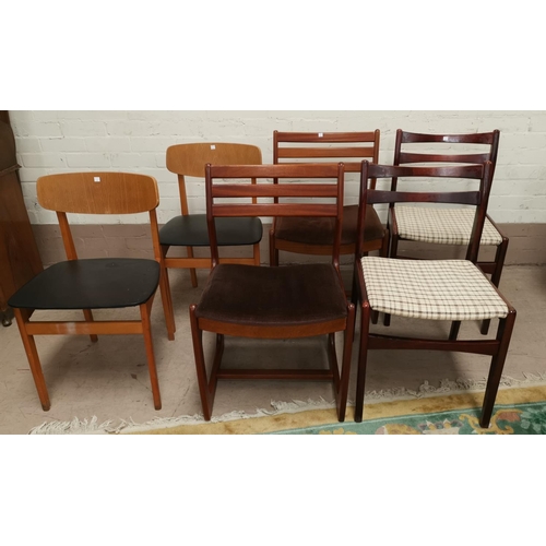 633 - A pair of teak dining chairs; a pair of light oak dining chairs and another pair of dining chairs