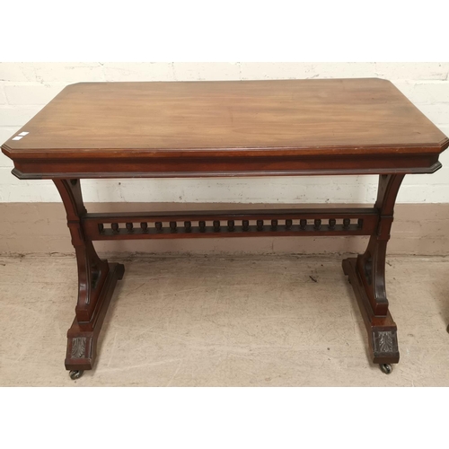 646 - A late 19th / early 20th century walnut Gothic style library table with carved and pierced supports ... 