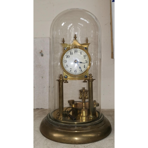 401 - An early 20th century brass 400 day clock under glass dome; a carved Black Forest figure; a bronzed ... 