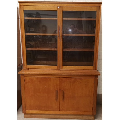 636 - A mid 20th century golden oak bookcase with glazed top above double cupboard, height 71