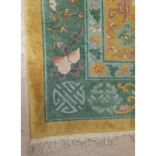 639 - A large Chinese yellow ground carpet, 140