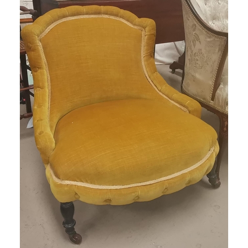 561 - A Victorian nursing chair with low seat, on turned legs, gold upholstery
