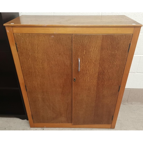 634 - A mid 20th century light oak double cupboard, Height 42