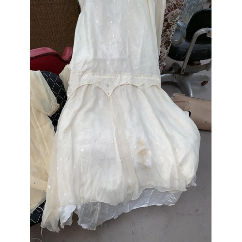432 - A vintage wedding dress and accessories; other costume; leather bag; etc.