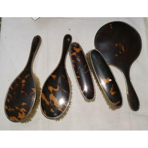377 - A five piece HMS and tortoiseshell dressing table set, hand mirror, two brushes and two other brushe... 
