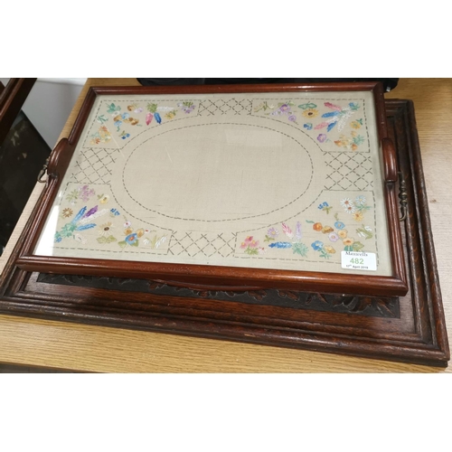482 - A carved oak rectangular tray; another; 2 inlaid mahogany trays; another with embroidery