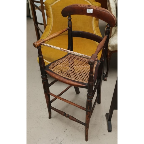 598 - A Victorian child's high chair with cane work seat, on turned column supports
