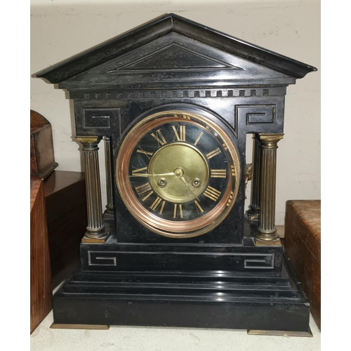 610 - A mantel clock in architectural slate case with brass side columns
