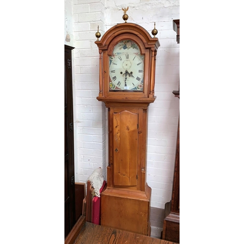 590 - A 19th Century longcase clock, arch top hood with turned pillars and brass finials, quarter reeded c... 