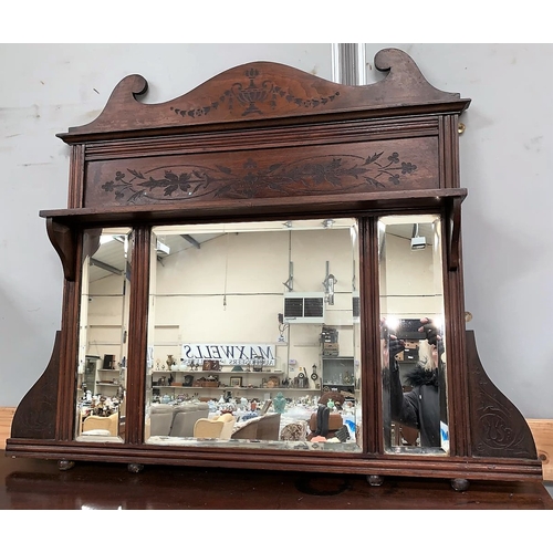 601A - An Edwardian overmantel mirror in stained frame with classical decoration