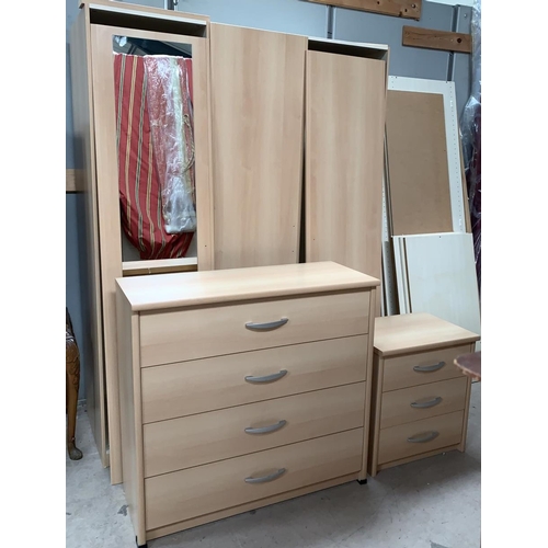 570 - A large modern light bedroom suite comprising 4 door wardrobe (3 mirrored) a 4 height chest of drawe... 