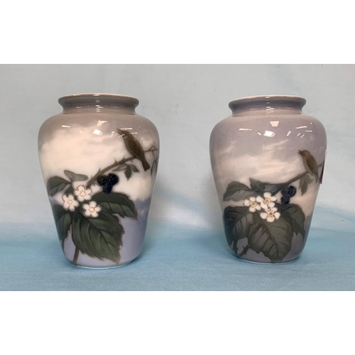 245 - A pair of Royal Copenhagen vases decorated with birds in flowering branches, height 4