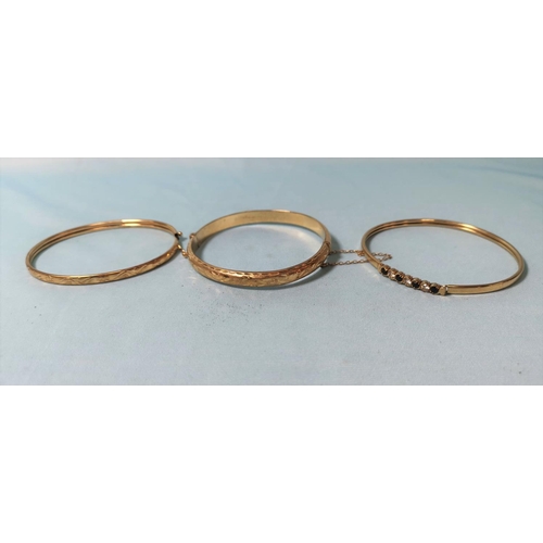 284 - Two 9 carat gold stiff hinged bangles; an another (unmarked), gross weight 19.4 gm