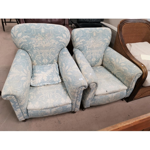 567 - A pair of Edwardian arm chairs upholstered in traditional blue fabric