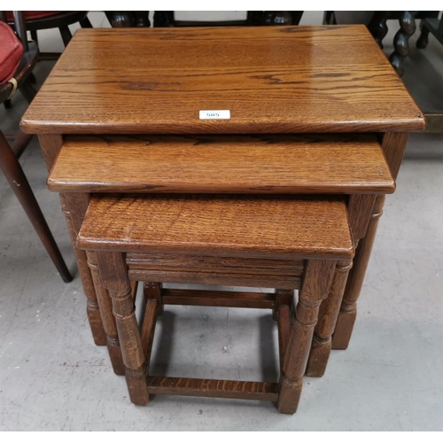 585 - A mahogany Regency style 2 division Canterbury; a nest of 3 oak tables