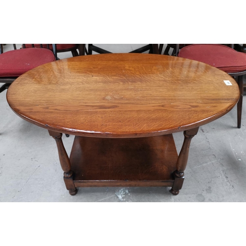 586 - A period style distressed oak 2 tier oval coffee table, on turned legs, in the style of Titchmarsh &... 