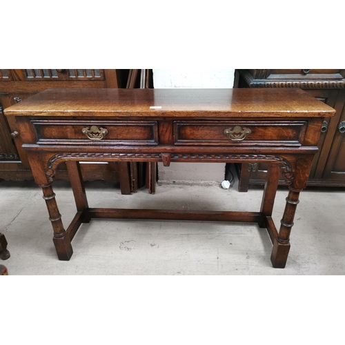 588 - An 18th century style distressed oak side table with 2 frieze drawers, on turned legs, by Titchmarsh... 