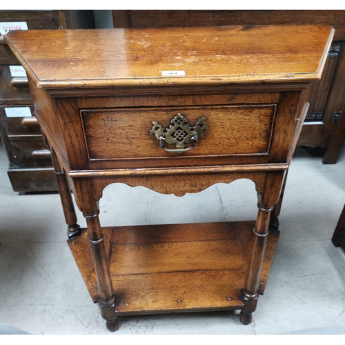 589 - An 18th century style distressed oak credence table with frieze drawer and undershelf, in the style ... 