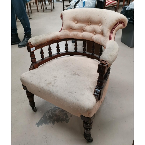 591 - A Victorian walnut framed tub armchair with bobbin turned gallery back