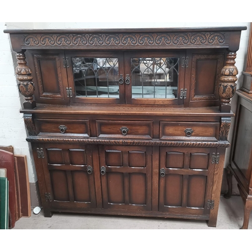 600 - A dark stained oak court cupboard with glazed centre section, 54