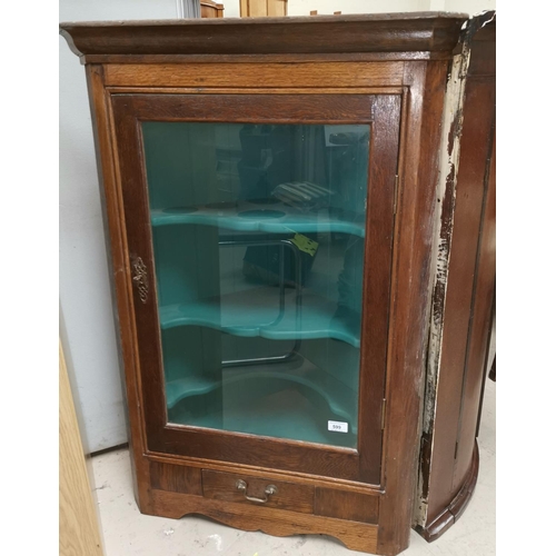 599 - A Georgian oak corner cupboard, the door later glazed enclosing interior with shaped shelves