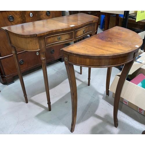 594 - A crossbanded mahogany reproduction hall table with serpentine front; a similar demi-lune table