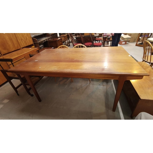 576 - A 1960's teak rectangular dining table on square legs (top scratched)