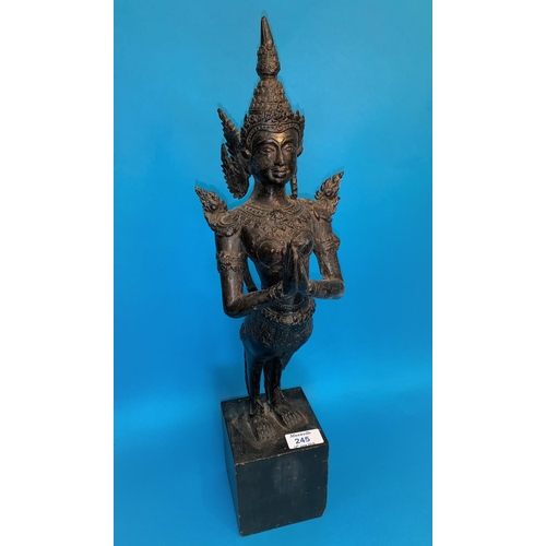 245 - A Thai bronze figure of a goddess with hands folded in prayer and long tail on wooden plinth, height... 