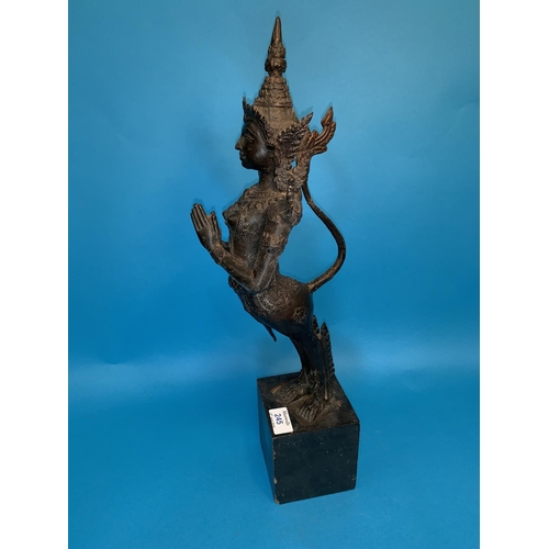 245 - A Thai bronze figure of a goddess with hands folded in prayer and long tail on wooden plinth, height... 