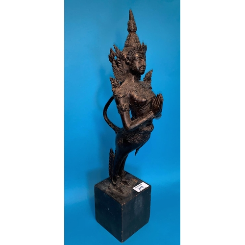 245 - A Thai bronze figure of a goddess with hands folded in prayer and long tail on wooden plinth, height... 