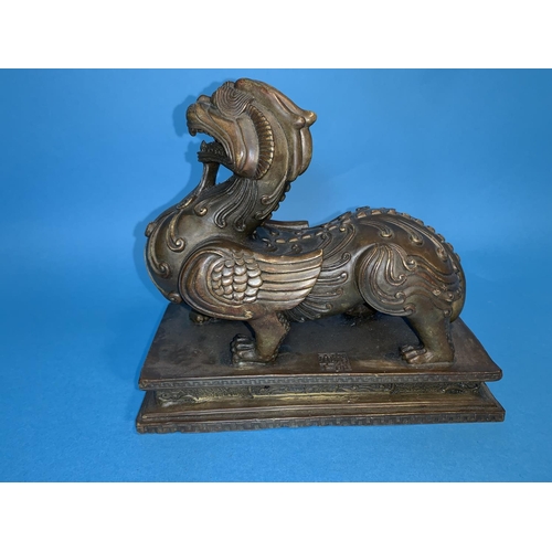 246 - A 19th century Chinese bronze depicting a mythical beast with dog of fo head and dragon legs with sq... 