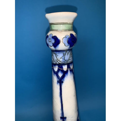 274 - A Persian Iznik bottle shaped vase decorated with flowers in blues and greens, height 12.52 (neck br... 