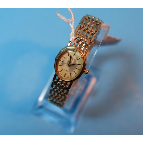 395 - A ladies 9 carat hallmarked gold wristwatch on integral gate bracelet strap, 18 gm gross