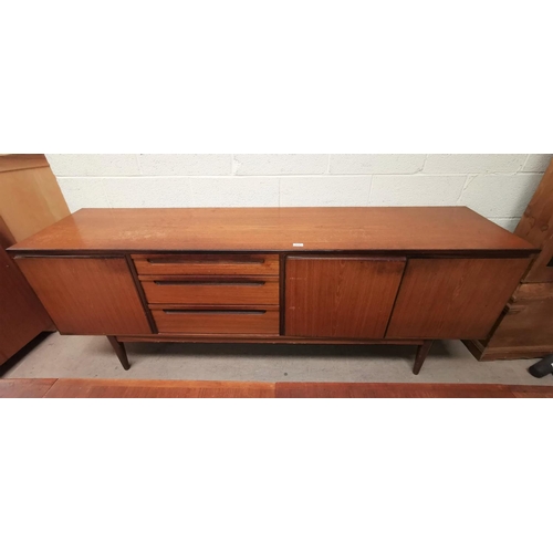 574 - A 1960's teak lowline sideboard with 3 drawers, one double and one single cupboard, by Alfred Cox, l... 