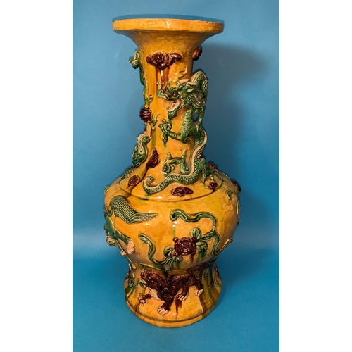 241 - A large Chinese Sancai baluster vase decorated with dragons in relief, under yellow, green and brown... 