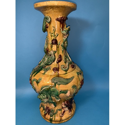 241 - A large Chinese Sancai baluster vase decorated with dragons in relief, under yellow, green and brown... 