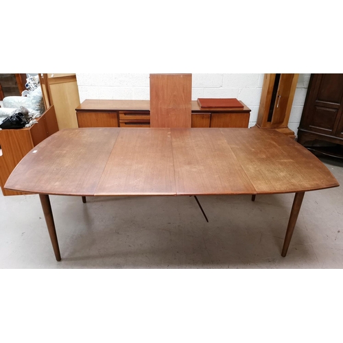 573 - A 1960's Danish teak dining suite comprising large rounded rectangular table with 3 spare leaves, ex... 